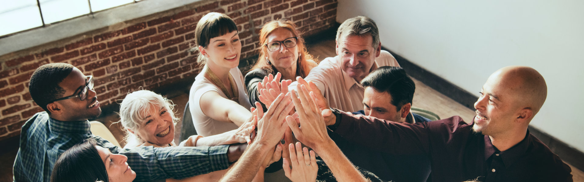 group of people putting their hands together